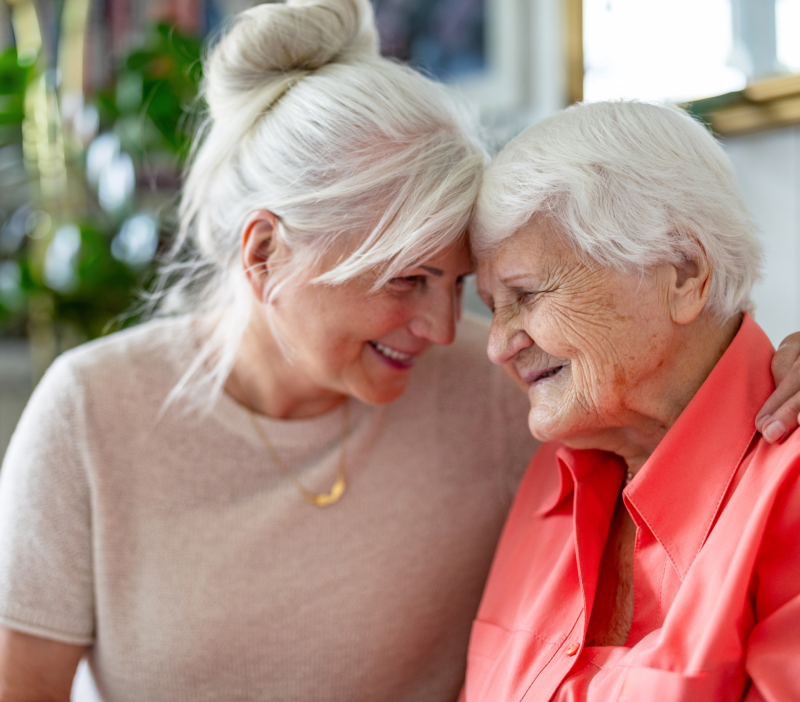 Daughter embracing her older mother